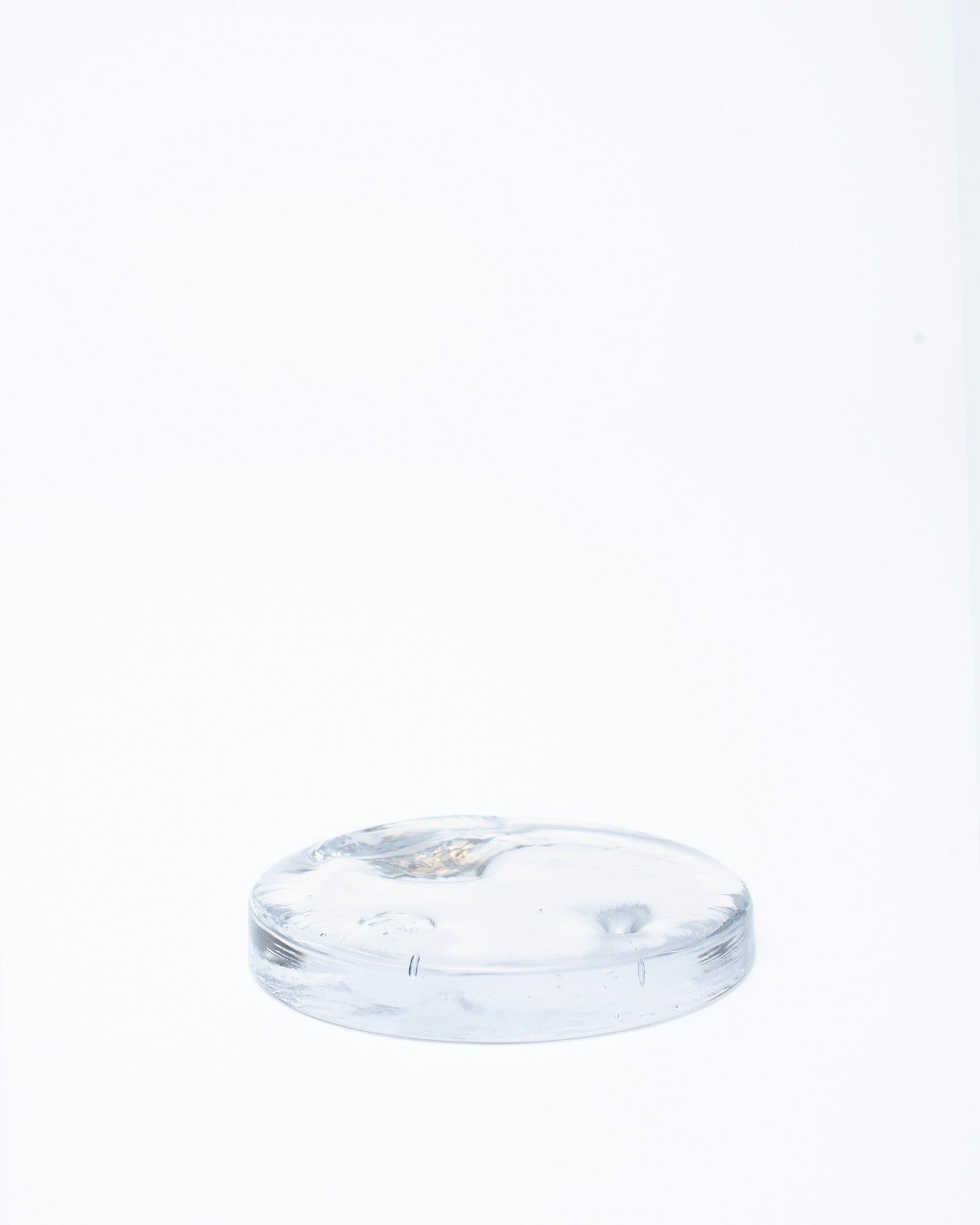 Handmade glass incense burner lit on wooden table